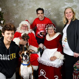 A photo of Mike's family with Santa and Mrs. Claus