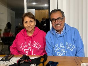 My dad and stepmom in matching his and hers Miami hoodies.