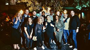 A bunch of awesome design systems folks standing in front of a flaming fountain in New Orleans.