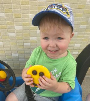 Ryan holding a smiley face cookie