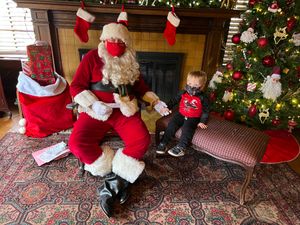 Ryan holding hands with Santa Claus, Covid-style