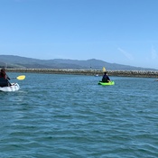 A person kayaking on a lake.